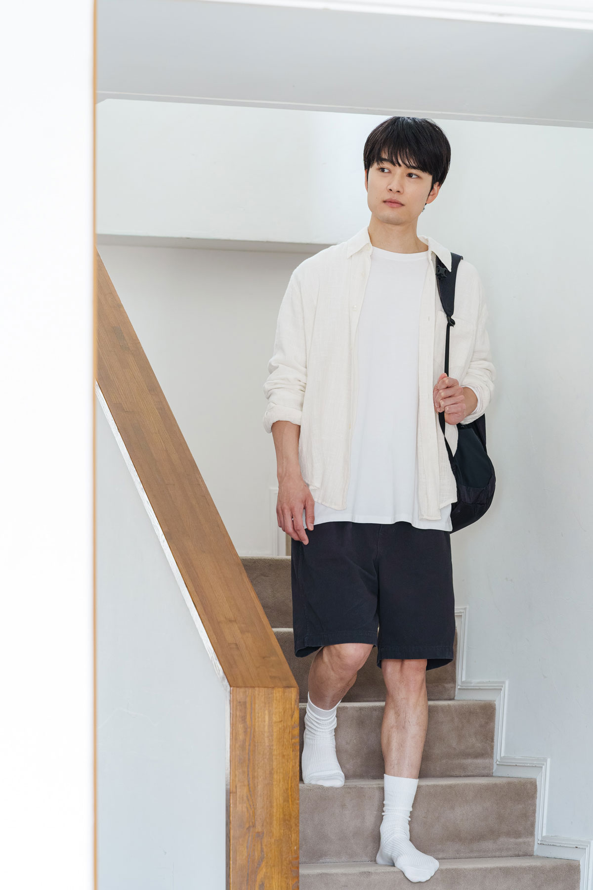 階段を降りる入江甚儀さん